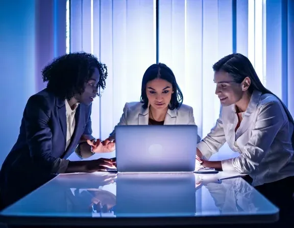 A small web development team working together at a bright studio desk