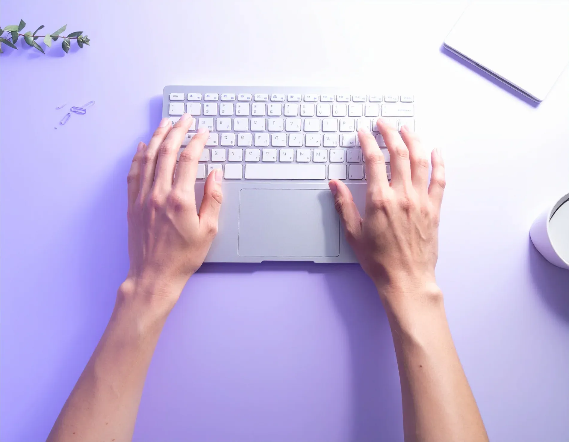 Developer hands typing on a keyboard, top-down